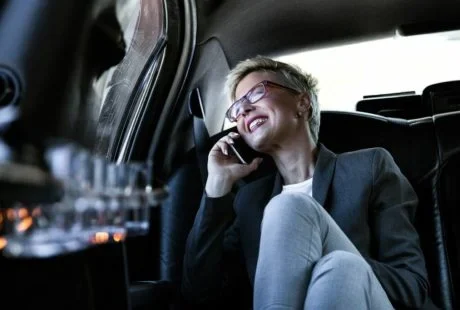 Woman traveling happily in samsedan's luxury vehicle